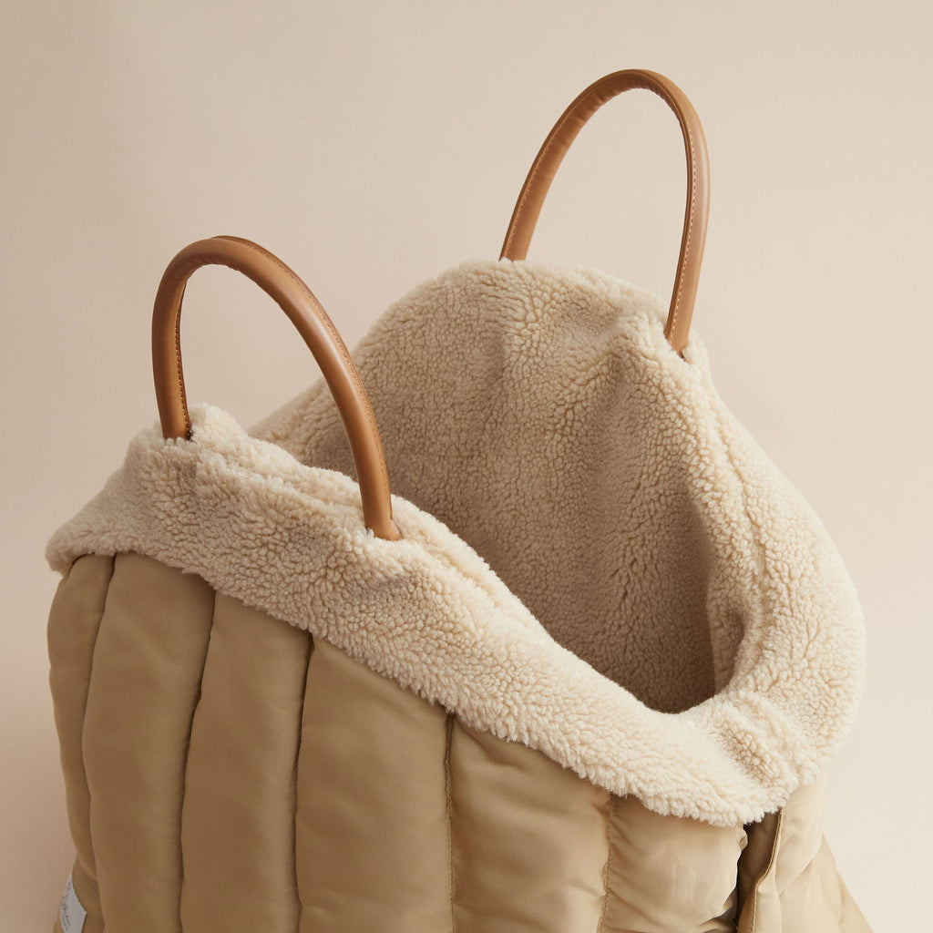 URBAÈ Metropolitan Car Sanctuary in Sand, showing the plush interior and secure vehicle attachment straps