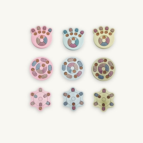 Cognitive Enrichment Puzzle Feeder for dogs and cats, highlighting the treat-dispensing chambers and high-contrast pink, blue and green design.